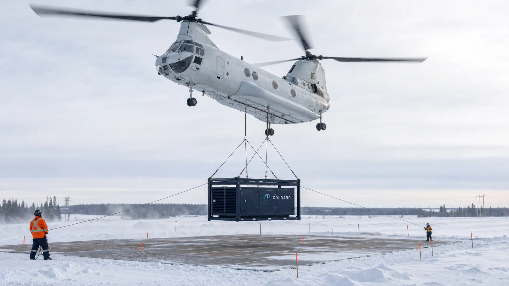 Conceptual heavy-lift placement of a modular compute enclosure on a remote snow pad